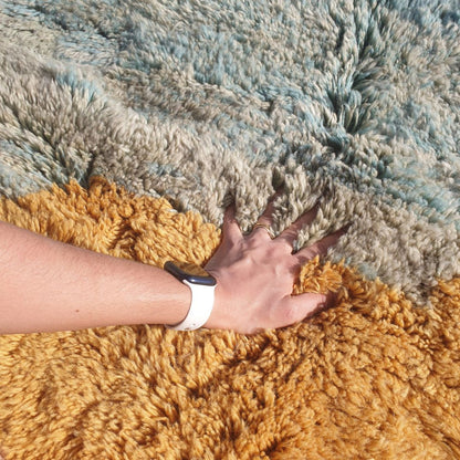 Close-up of a luxurious Beni Mrirt Moroccan rug showing an incredibly thick and plush natural wool pile with a painterly color-block gradient — soft teal fading into mustard yellow and warm dusty salmon rose — the extraordinary density and softness of authentic Beni Mrirt craftsmanship visible in every fibre