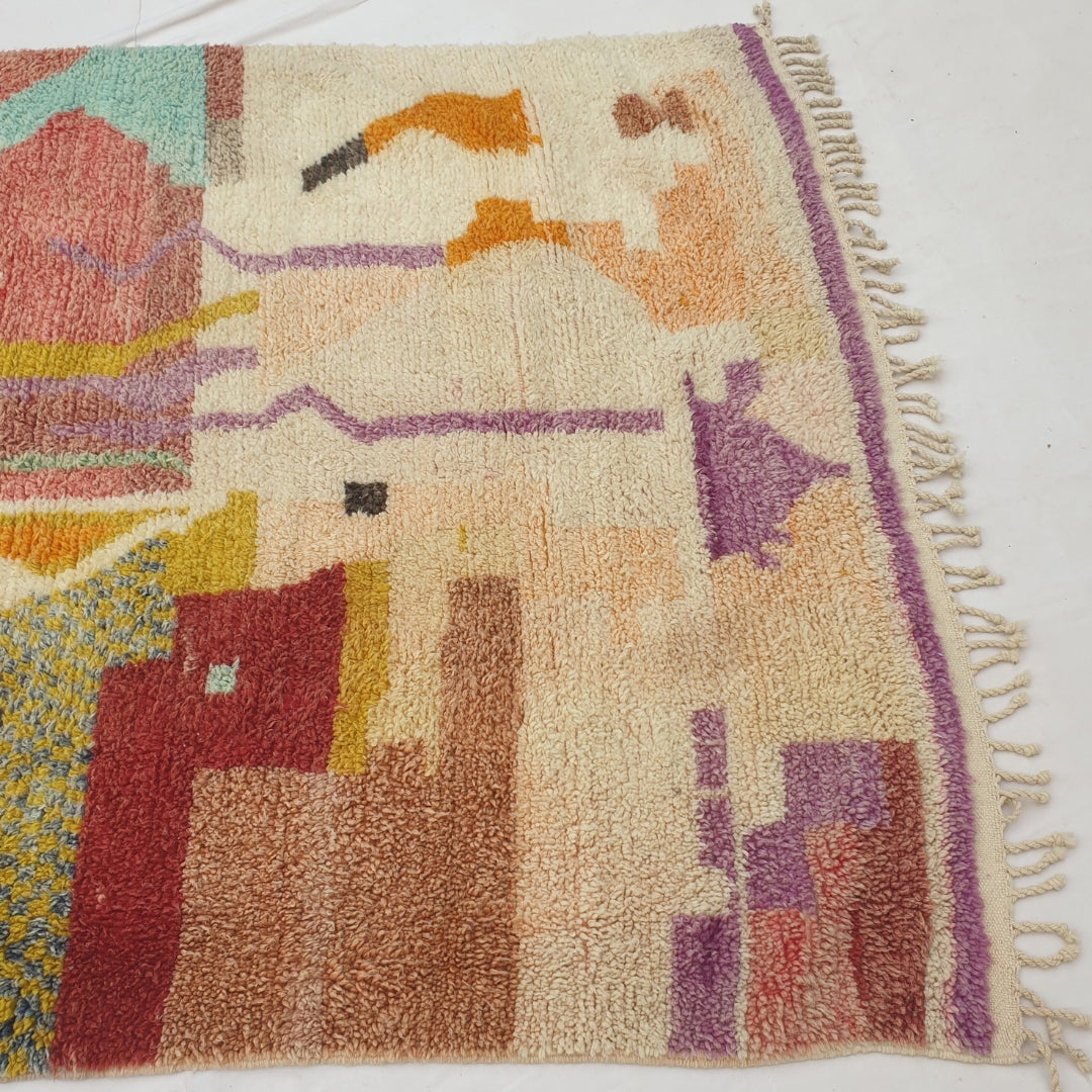 Detail shot of the purple line accents and border stripe on Makyna Moroccan rug - the delicate vertical drip-like marks running through the muted pastel composition, with the solid purple stripe visible along the edge