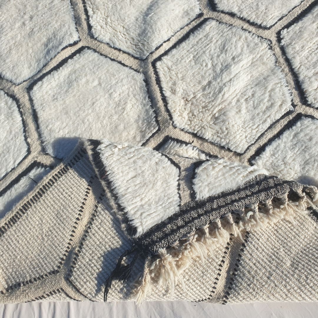 Hand-knotted fringe and detailed black border framing the honeycomb pattern on 6x9 classic Beni Ourain Moroccan rug