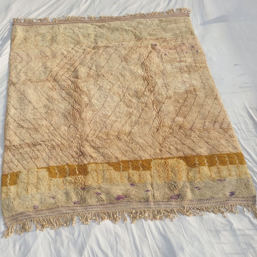 Full view of 8x10 Beni Mrirt rug with fringed edges and intricate abstract geometric design in pale nude pink tones showing exceptional craftsmanship