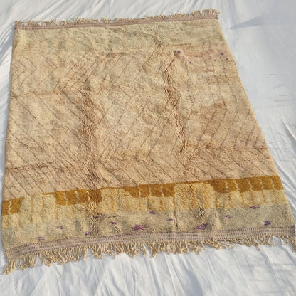 Full view of 8x10 Beni Mrirt rug with fringed edges and intricate abstract geometric design in pale nude pink tones showing exceptional craftsmanship