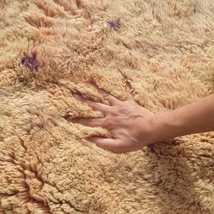 Close-up of super dense thick shag pile and soft natural wool texture on handmade Beni Mrirt pale nude pink rug