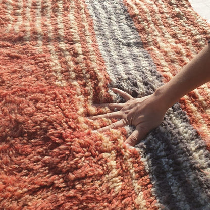 Close-up of dense ultra-plush shag pile and soft natural wool texture on handmade Beni Mrirt terracotta and gray runner