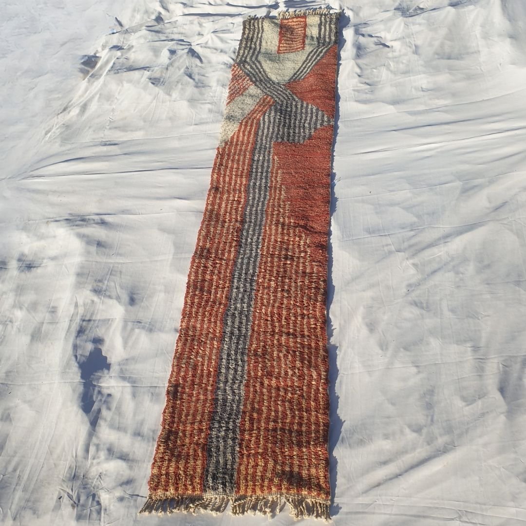 Full elongated view of 2x12 runner featuring fringed edges, earthy terracotta-beige-gray color palette, and high-pile craftsmanship of plush Berber carpet