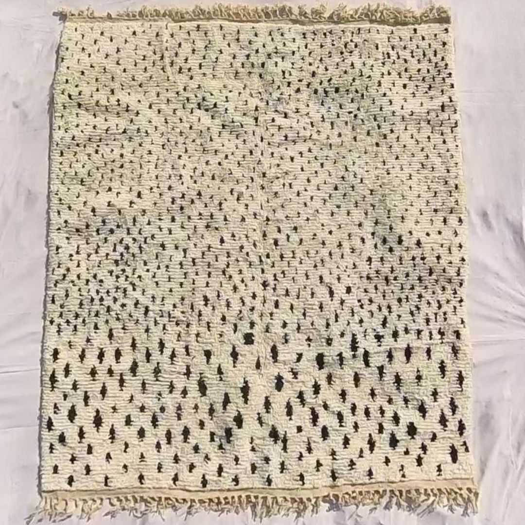 Full view of 8x10 Boujad rug with fringed edges and all-over black and white abstract pattern showing traditional craftsmanship