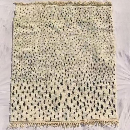 Full view of 8x10 Boujad rug with fringed edges and all-over black and white abstract pattern showing traditional craftsmanship