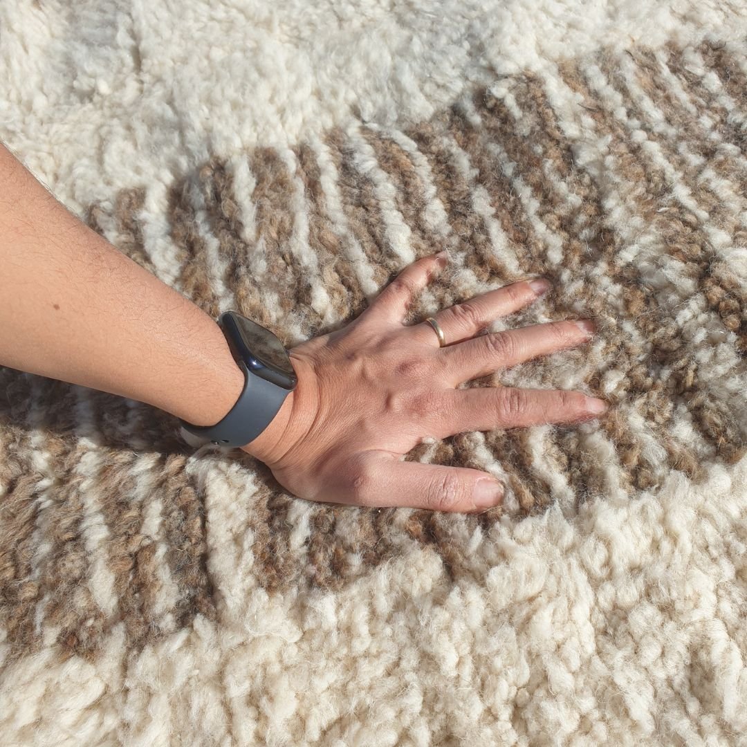 Ultra fluffy thick high-pile wool texture detail of ivory Beni Ourain plush shag rug