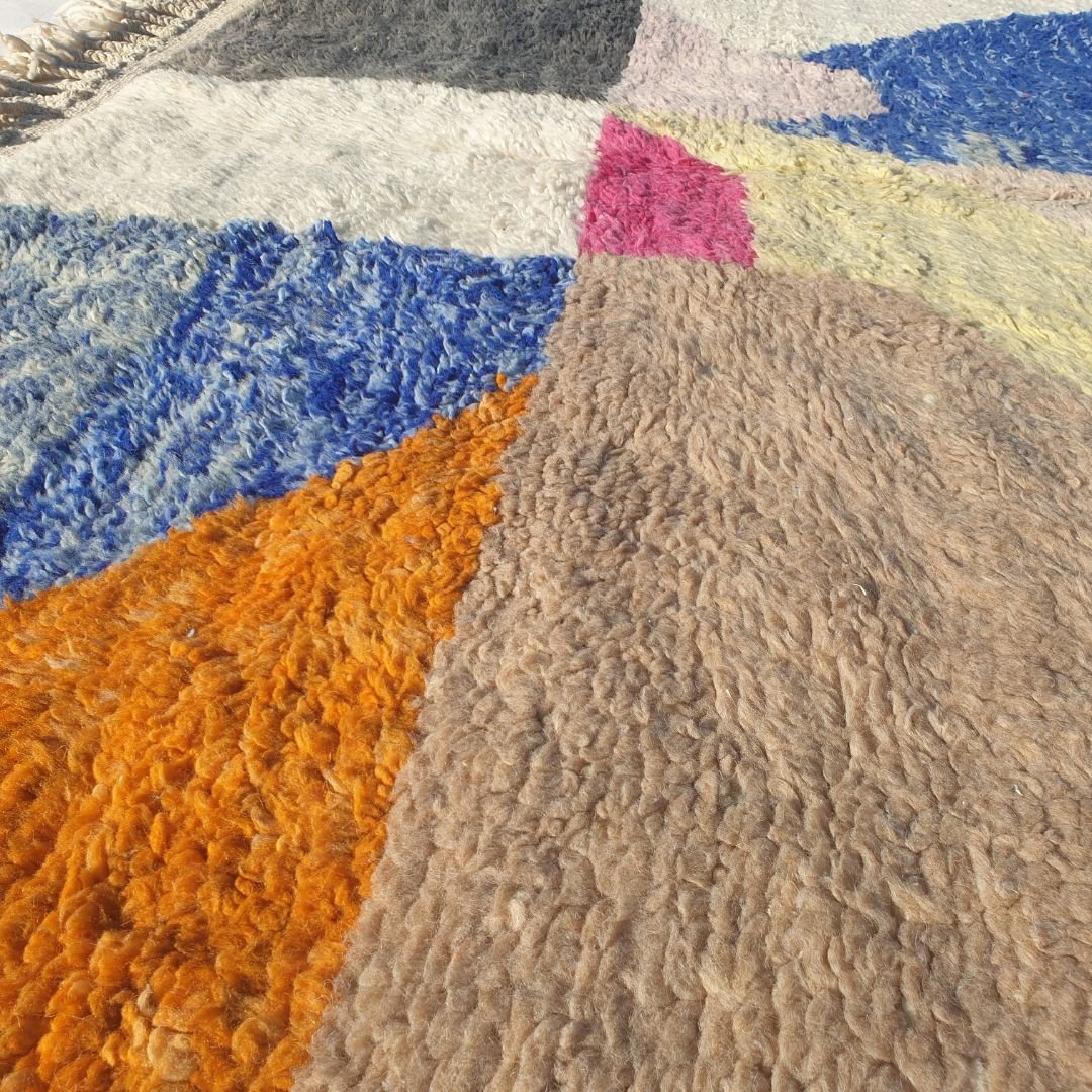 Luxuriously thick, plush high-pile wool of colorful abstract Beni Ourain Berber rug showing soft fluffy depth and natural color variations