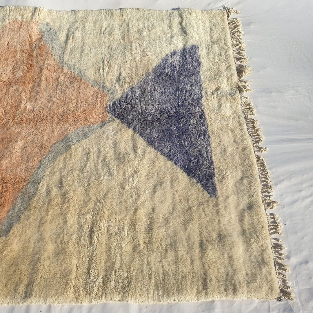 Bold navy triangle and warm pastel red accents on authentic Beni Mrirt Moroccan wool rug