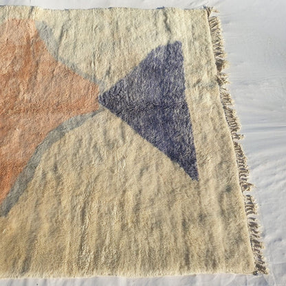Bold navy triangle and warm pastel red accents on authentic Beni Mrirt Moroccan wool rug