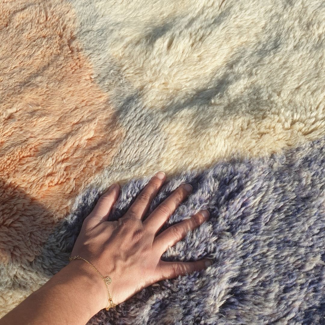 Soft fluffy high-pile wool texture detail of pastel red Beni Mrirt luxury shag rug