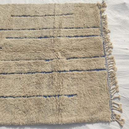 Ifawa - Beni Ourain Rug with Tonal Beige Field and Rare Blue Line Accents - Handwoven Berber Carpet | 6'6"x10'5" Ft | 198x317 cm - OunizZ