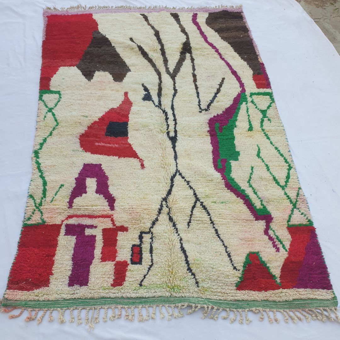 handwoven Boujad Berber rug (191x308 cm) laid flat on white, ivory ground dominated by a dramatic bare black tree centrepiece flanked by colourful tribal motifs in red, purple, green and brown.