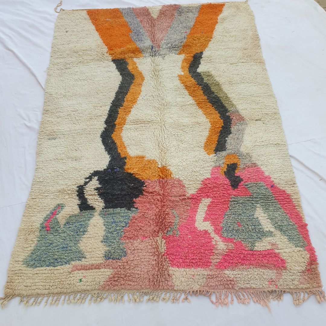 handwoven Boujad Berber rug (202x298 cm) laid flat on white, the full composition visible: ivory ground, twin orange zigzag lightning columns from the top, and bold abstract shapes in hot pink, slate blue, black and gold below.