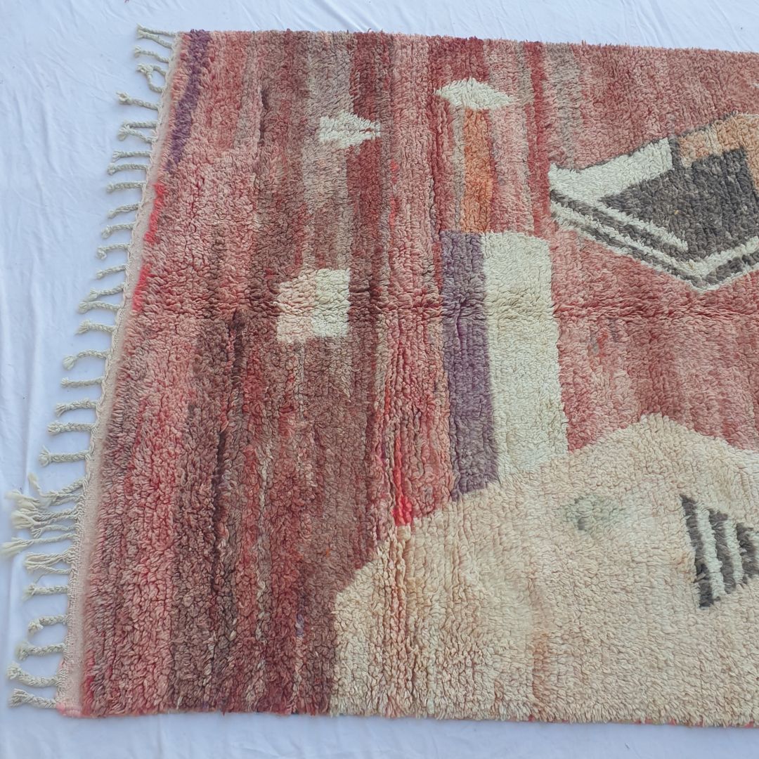 Detailed abstract geometric motifs in faded red, coral pink and cream on authentic Boujad Moroccan wool rug