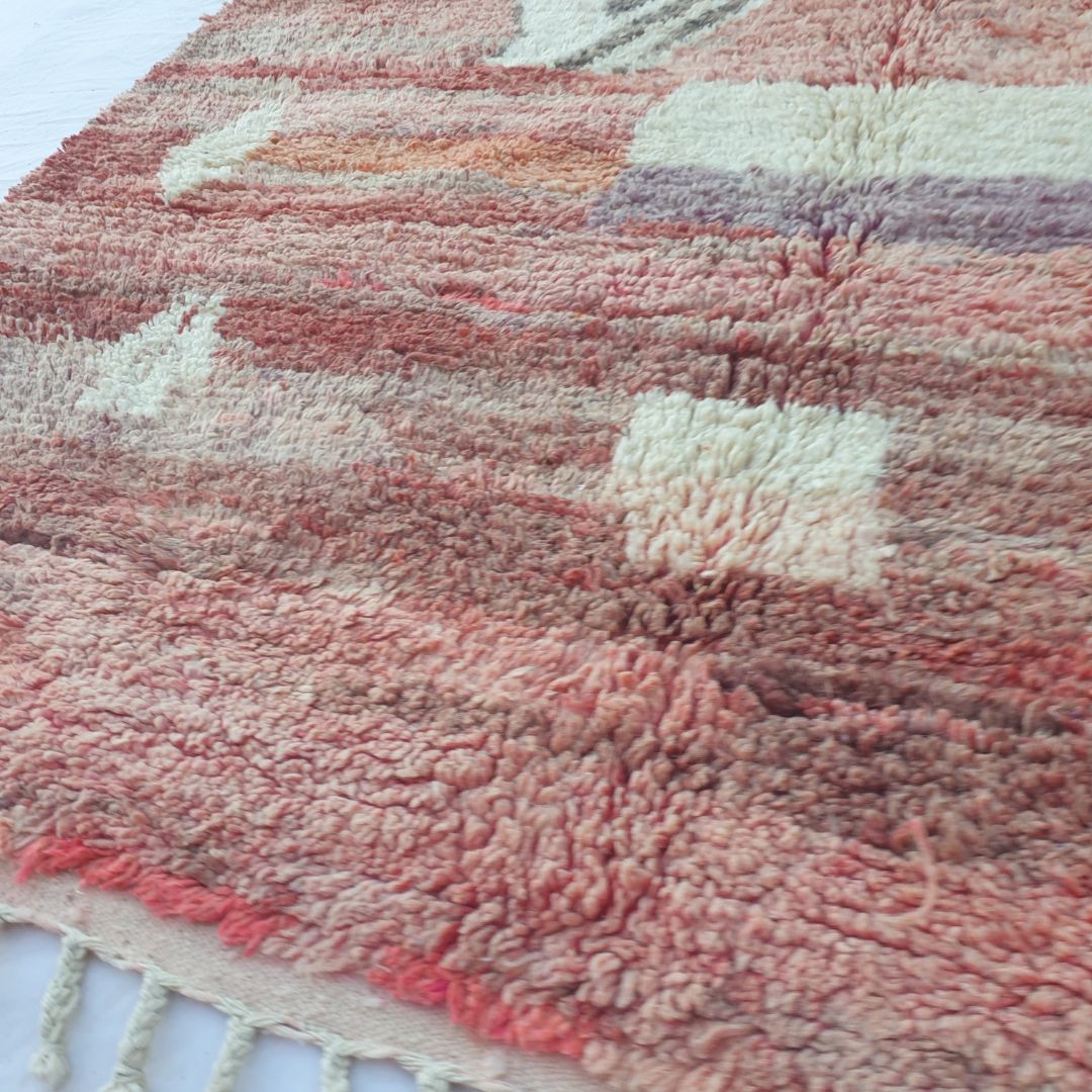 Soft handwoven wool pile of vintage red and pink Boujad Moroccan Berber rug showing rich texture and natural color variations