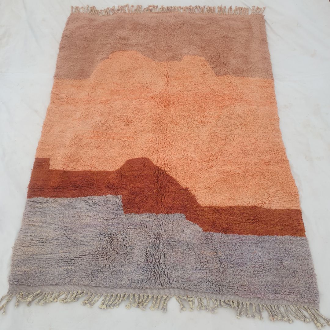 Fringe edge and serene sunset horizon layers on fluffy custom Moroccan shag carpet highlighting super soft wool and artistic gradient