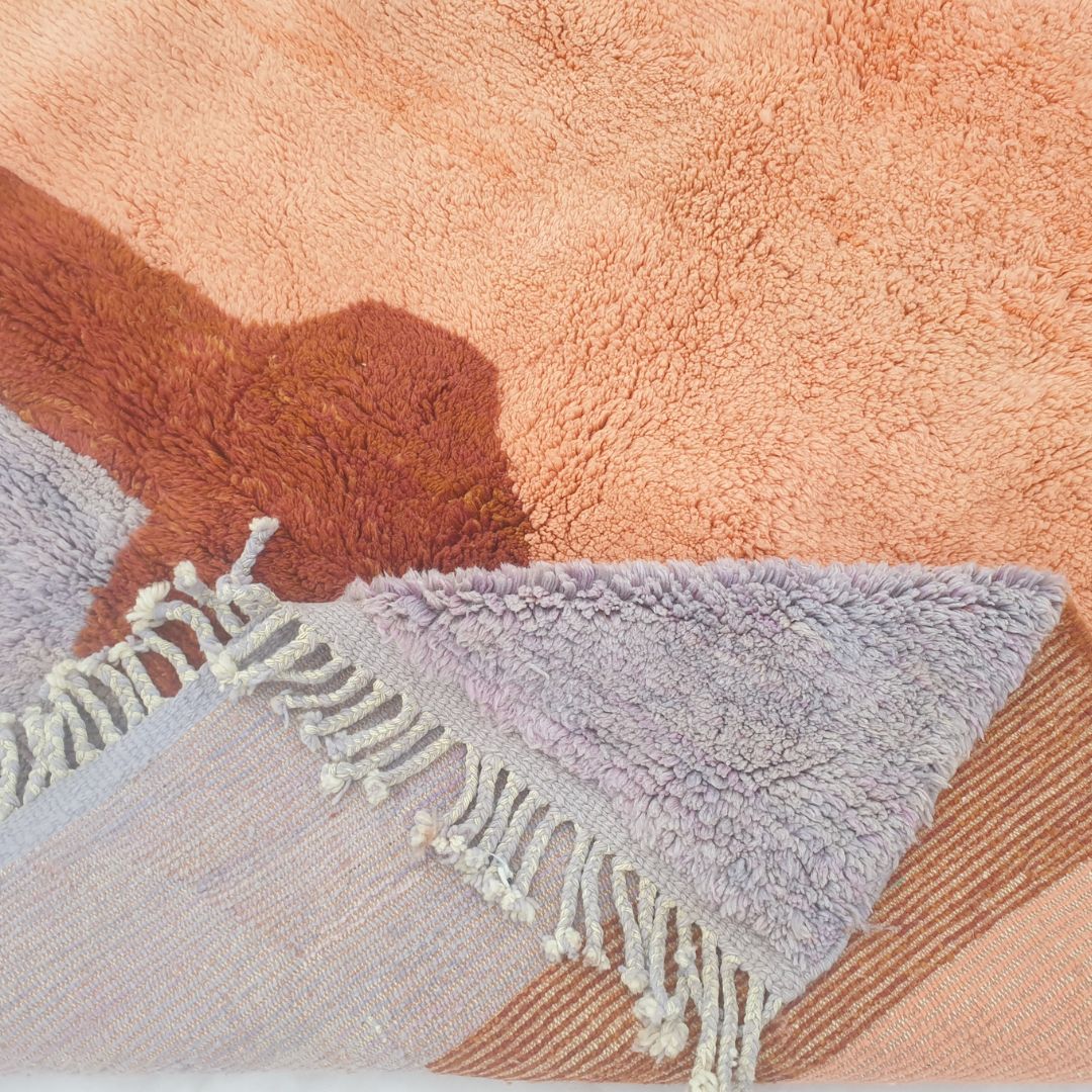 Soft lavender base blending into warm orange gradient in landscape-inspired Berber Moroccan rug – ultra thick shag pile detail