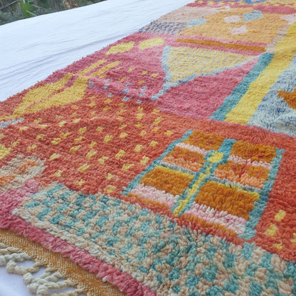 Vibrant pink yellow blue abstract patterns on handwoven Boujad Moroccan rug, joyful wool texture
