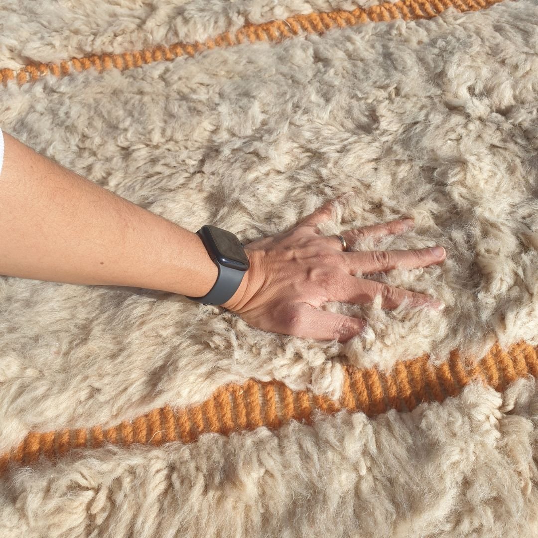 Ultra soft fluffy high-pile wool texture detail of ivory Beni Ourain plush shag rug