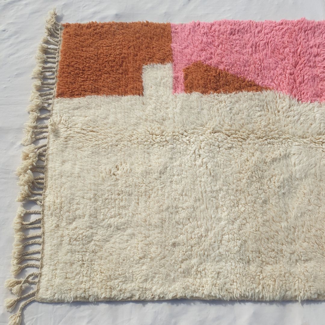 Warm terracotta orange and soft pastel pink color blocks on ivory field of authentic Beni Ourain Moroccan wool rug