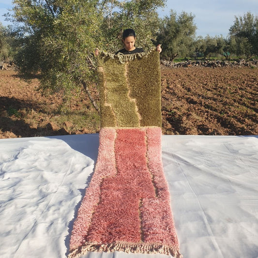 Luxury 2x10 Beni Mrirt Moroccan runner rug in olive green and pastel pink abstract wavy shag design held outdoors amid olive trees