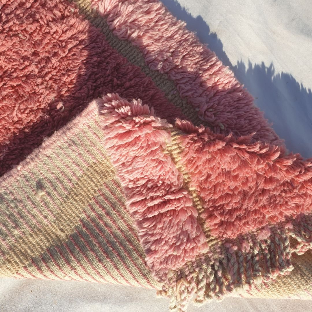 Vibrant pastel pink shag area contrasting with olive green abstract blocks highlighting thick weave and luxurious texture of Beni Mrirt runner