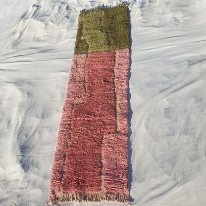 Full elongated view of 2x10 runner featuring fringed edges, bold olive green to pink color transition, and high-pile craftsmanship of plush Berber carpet