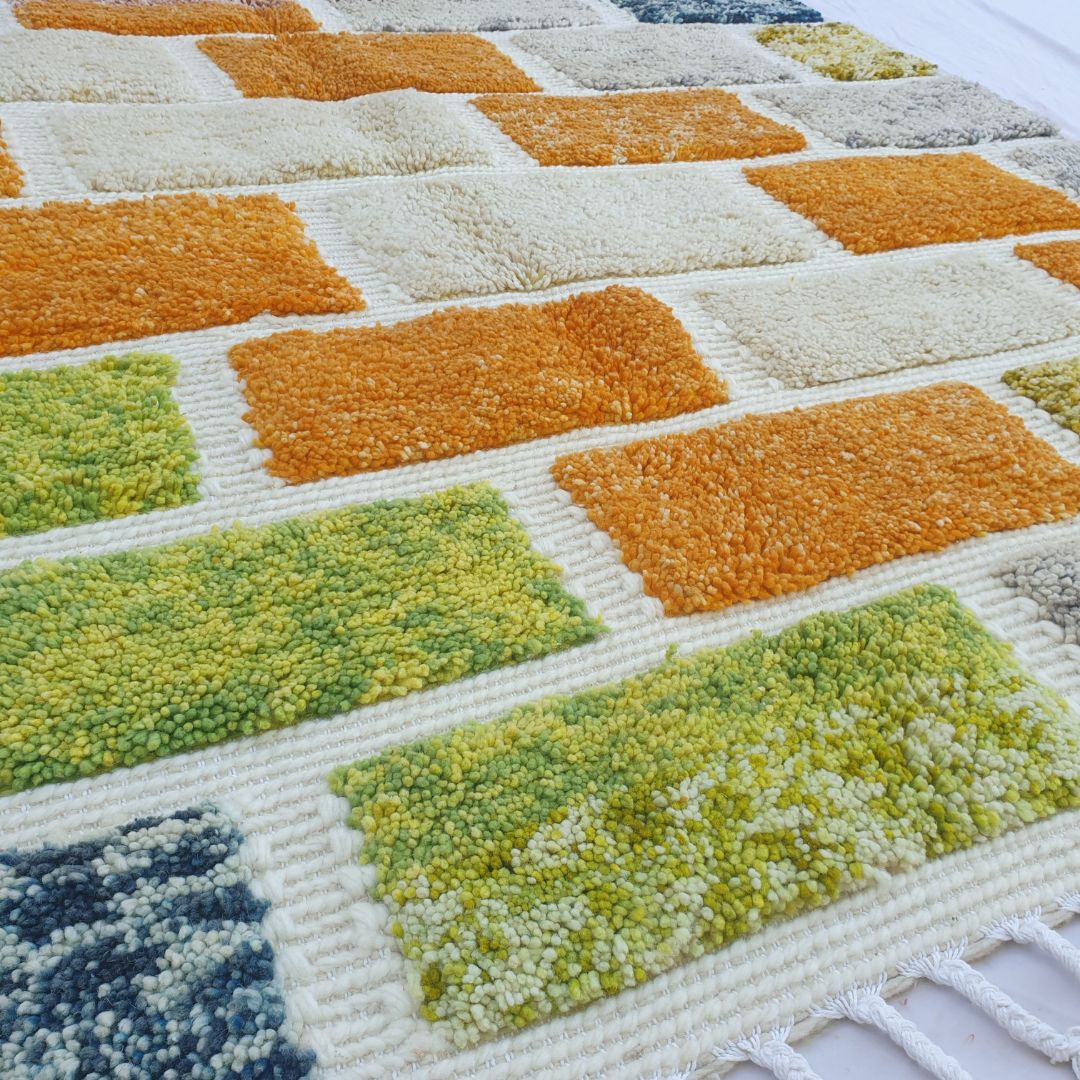 Fluffy high-pile detail on multicolored brick pattern Moroccan Beni Ourain shag rug, soft wool texture