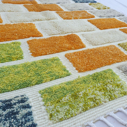 Fluffy high-pile detail on multicolored brick pattern Moroccan Beni Ourain shag rug, soft wool texture