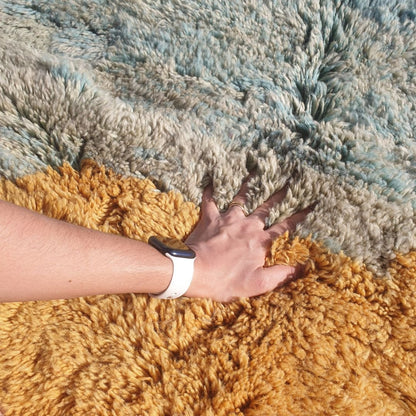 Close-up of a luxurious Beni Mrirt Moroccan rug showing an incredibly thick and plush natural wool pile with a painterly color-block gradient — soft teal fading into mustard yellow and warm dusty salmon rose — the extraordinary density and softness of authentic Beni Mrirt craftsmanship visible in every fibre