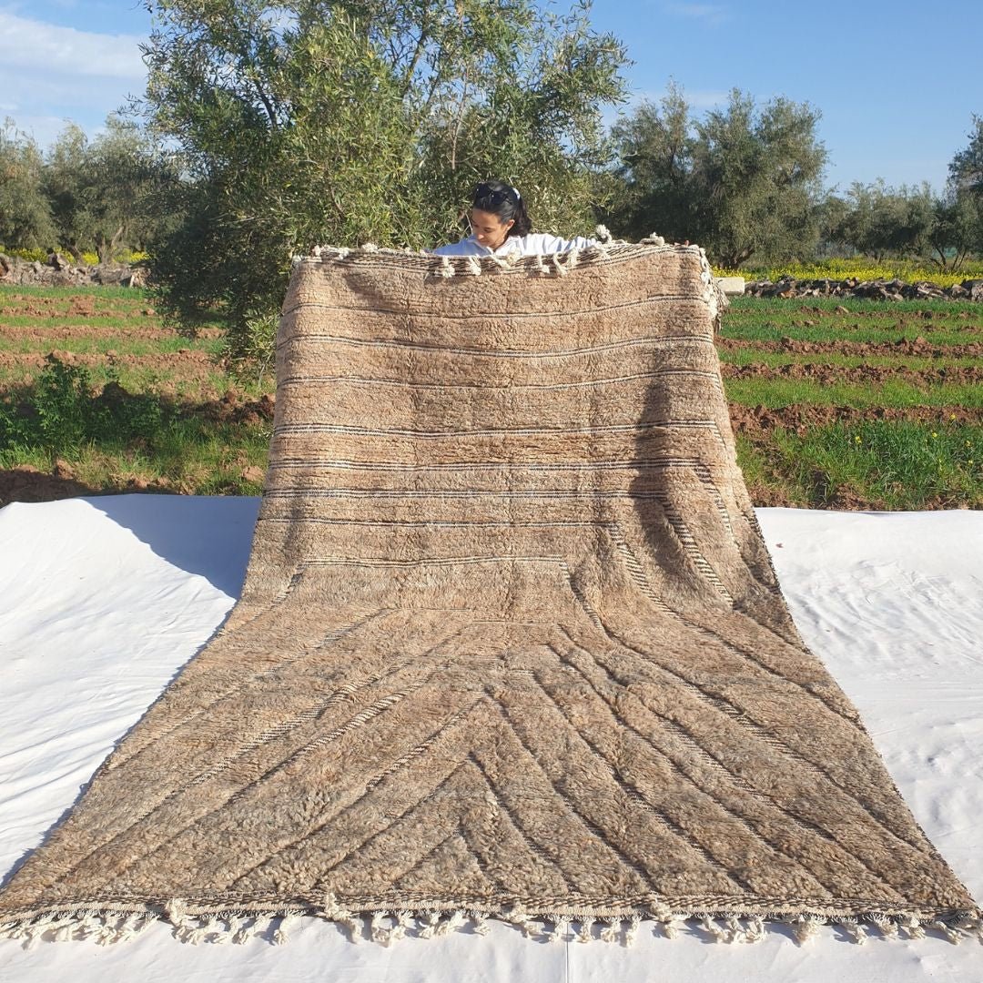 Soft 7x11 Beni Ourain Moroccan rug in cream beige with chevron geometric design and ultra thick plush pile held outdoors