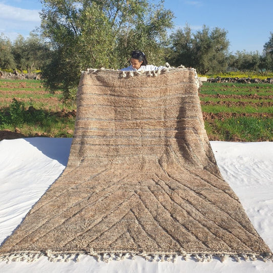 Soft 7x11 Beni Ourain Moroccan rug in cream beige with chevron geometric design and ultra thick plush pile held outdoors