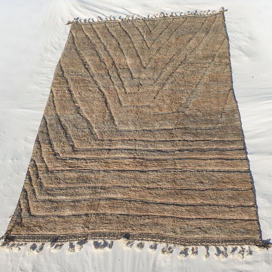 Dense plush pile and cozy beige variations in this sumptuous Beni Ourain Berber carpet