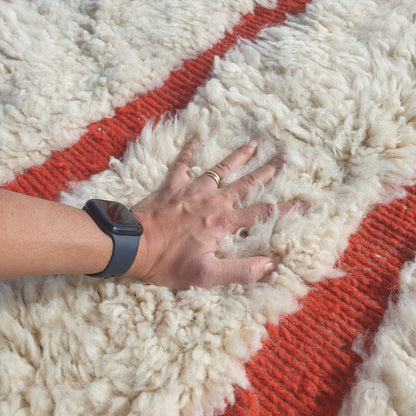 Ultra fluffy thick high-pile wool texture detail of ivory Beni Ourain plush shag rug