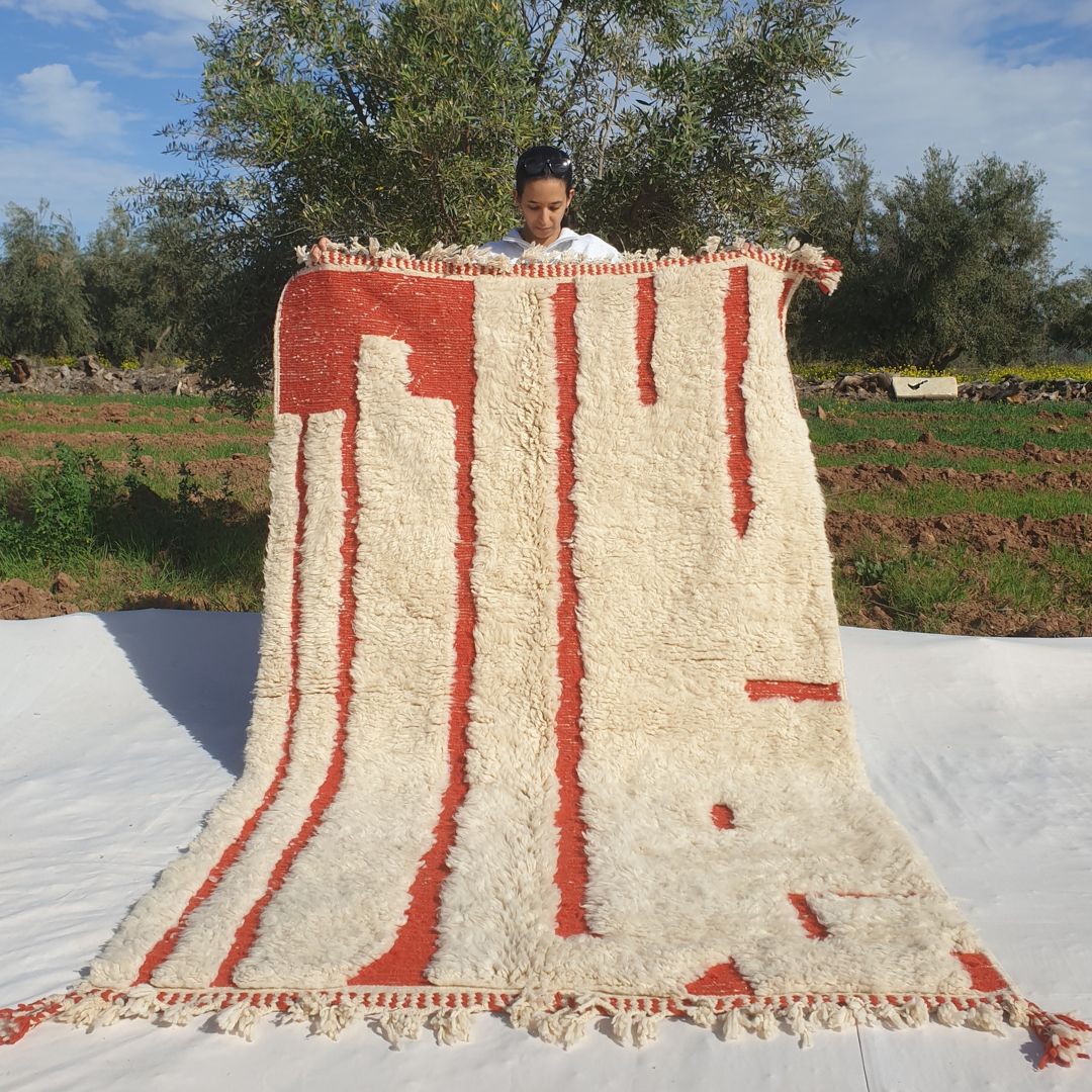 Super soft 5x8 Beni Ourain Moroccan rug in ivory with burnt orange vertical stripes ultra thick fluffy pile held outdoors