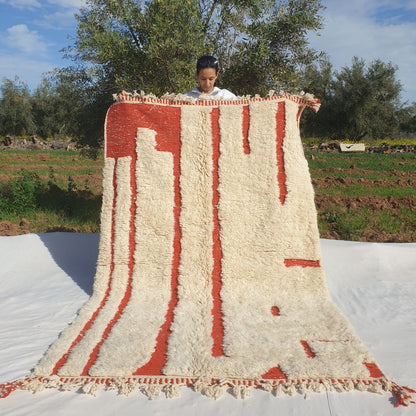 Super soft 5x8 Beni Ourain Moroccan rug in ivory with burnt orange vertical stripes ultra thick fluffy pile held outdoors