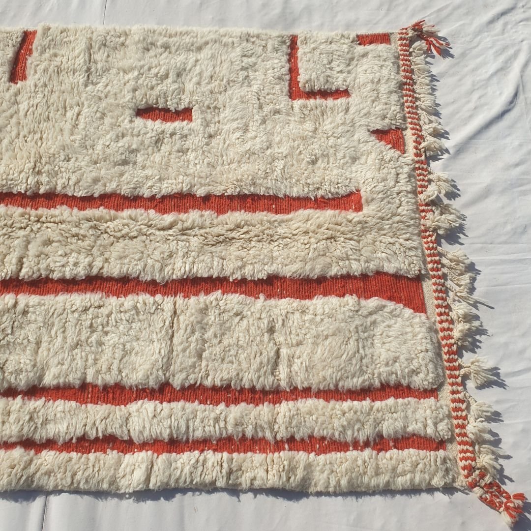 Warm burnt orange vertical stripes and bands on ivory field of authentic Beni Ourain Moroccan wool rug