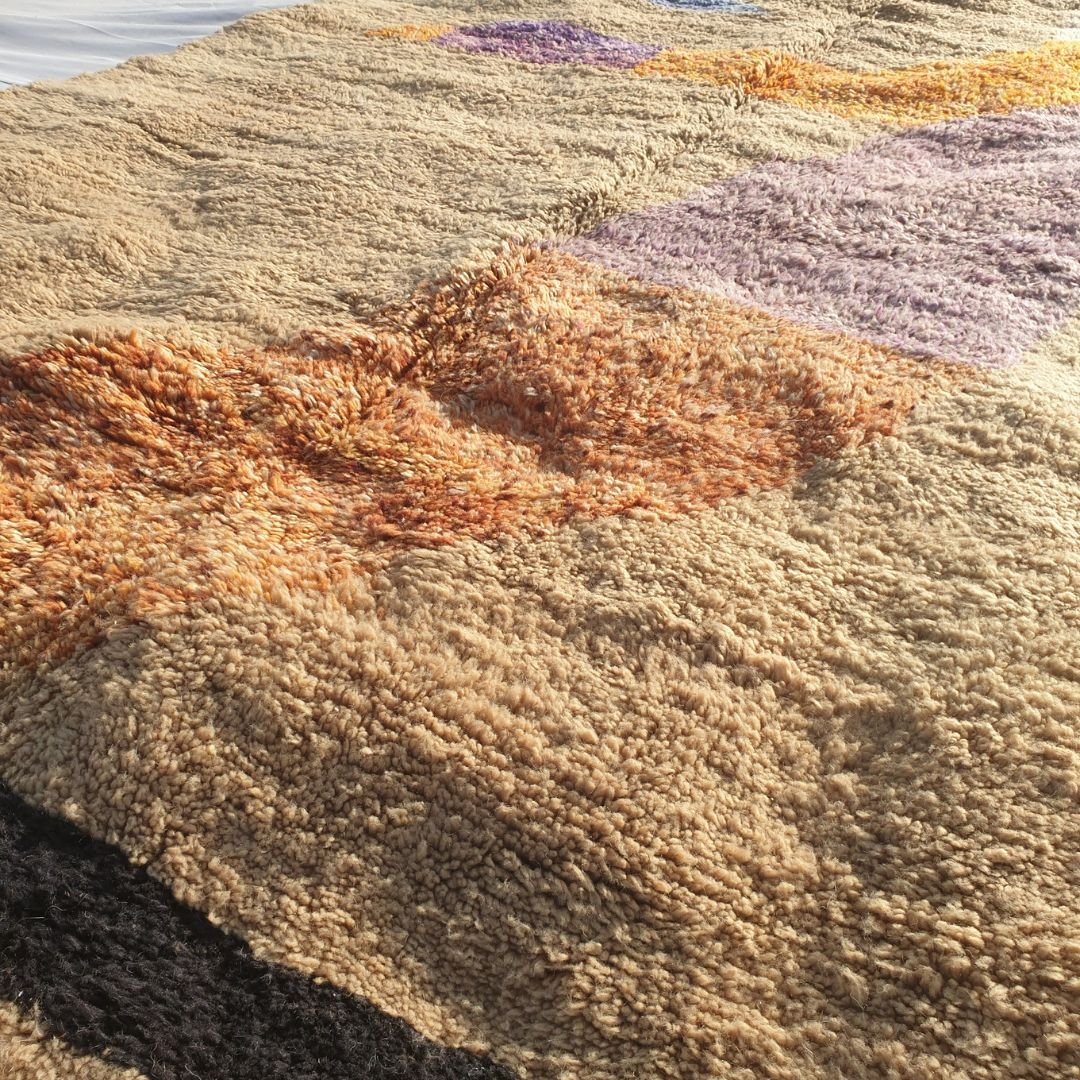 Black accent stripe and creamy beige background showing quality craftsmanship of the plush Beni Mrirt carpet