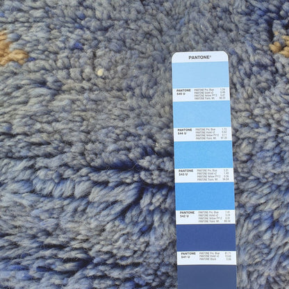 Vibrant blue geometric tribal design close-up on the colorful Moroccan Berber Beni Mrirt shag rug