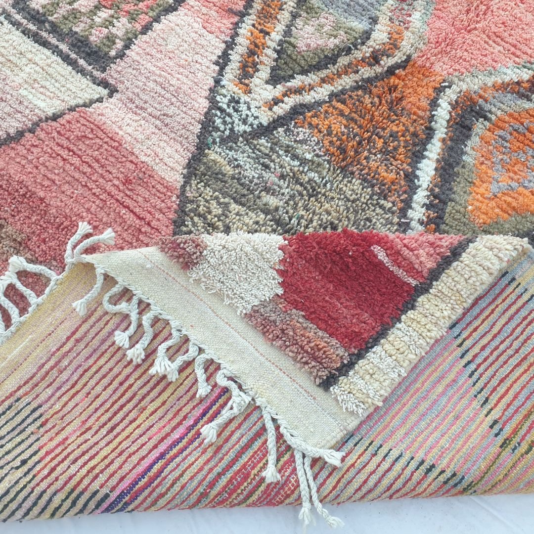 Hand-knotted fringe and border detail of 6x10 vibrant Boujad Moroccan rug in coral red and cream
