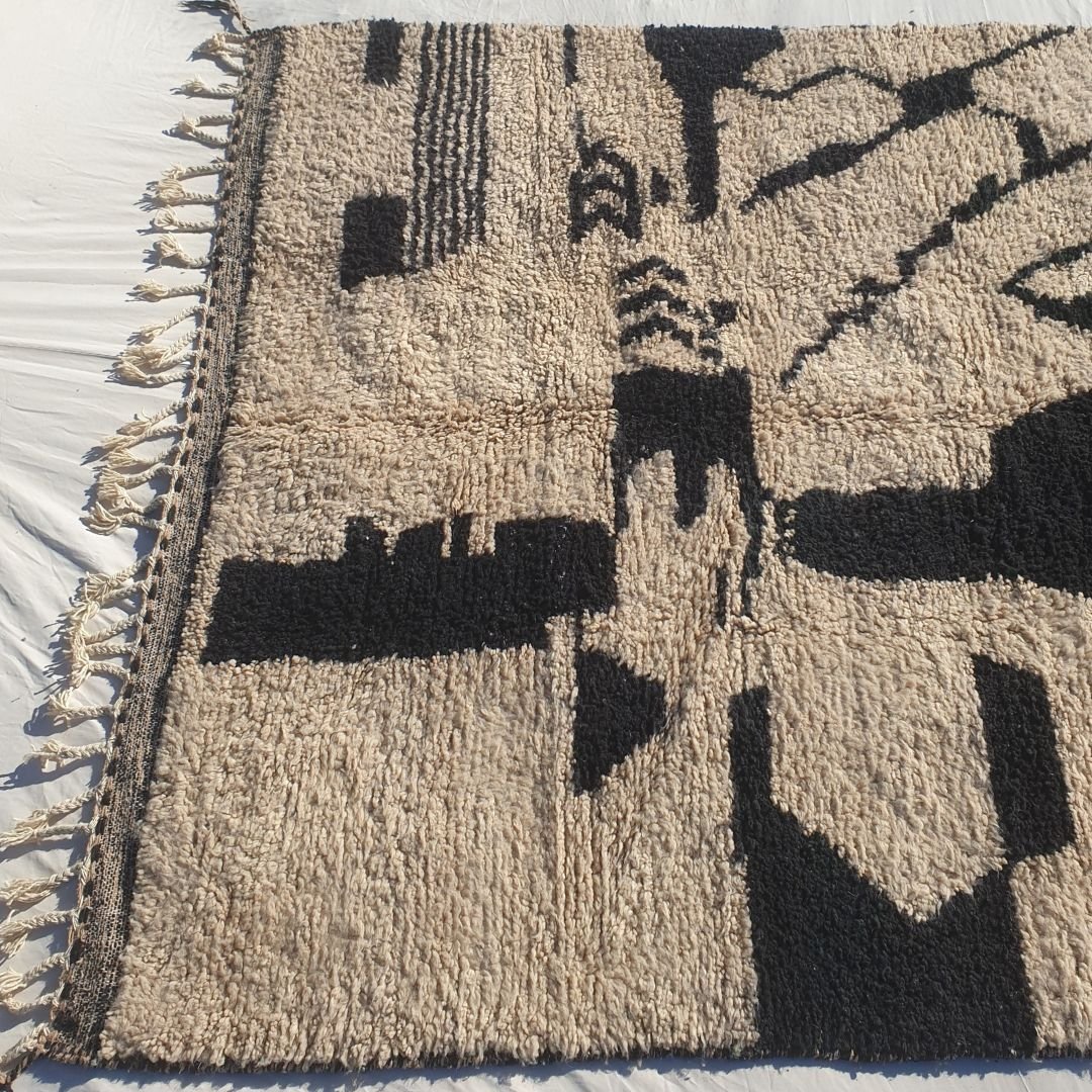 Thick, plush high-pile wool of black and white abstract Beni Ourain Berber shag rug with deep black contrasts and soft natural ivory background