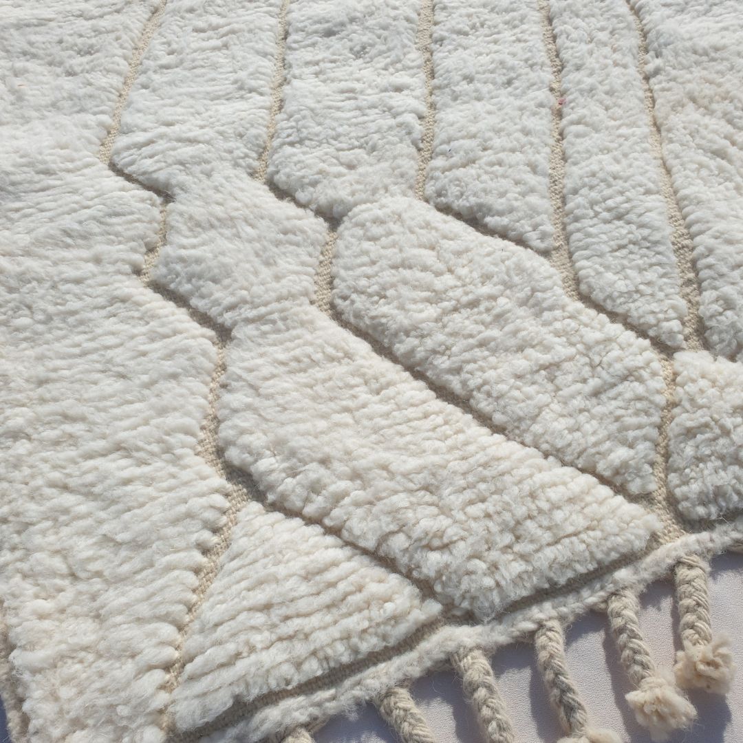 Ultra fluffy thick high-pile wool texture detail of white Beni Ourain plush shag rug