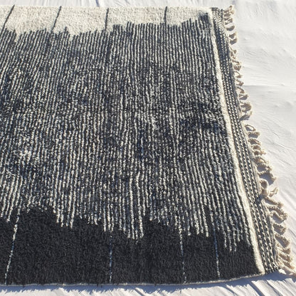 Thick, fluffy high-pile wool texture of black and white Beni Ourain Berber shag rug with soft natural ivory and deep black contrasts