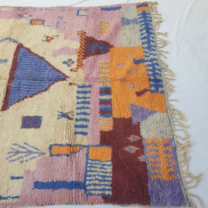 Lower half of Tescla Moroccan Berber rug showing bold colour blocks of deep burgundy, vibrant orange and cobalt blue with a soft purple patch and natural wool fringe.
