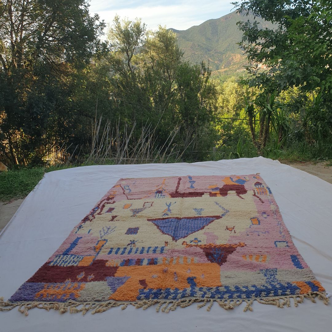Tescla – 6x9 Moroccan Rug – Pink Ivory Boujad Berber Handwoven Wool Carpet with Blue Triangle & Figurative Symbols | 6'7"x9'7" Ft | 201x294 cm - OunizZ