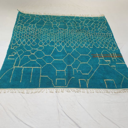 Luxuriously thick plush high-pile wool of teal honeycomb Beni Ourain Berber shag rug showing soft fluffy depth and rich natural color contrast