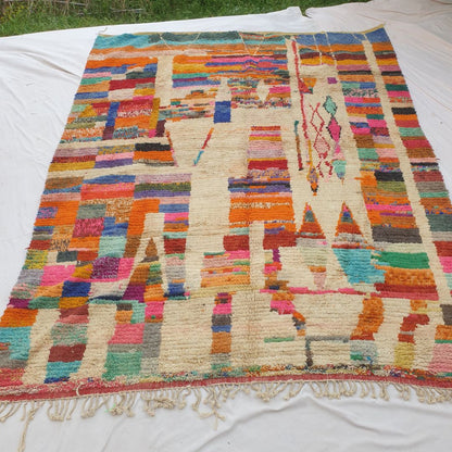 Authentic Boujad Moroccan rug 311×380 cm laid flat — cream ivory background structured into a patchwork mosaic by vertical cream bands alternating with dense horizontal multicolor stripes in orange, teal, red, pink, blue, yellow and green, handmade in Morocco by Berber women