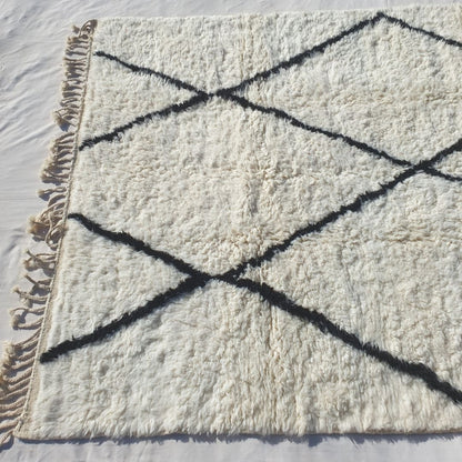 Interconnected black diamond lattice grid on bright white field of authentic Beni Ourain Moroccan wool rug