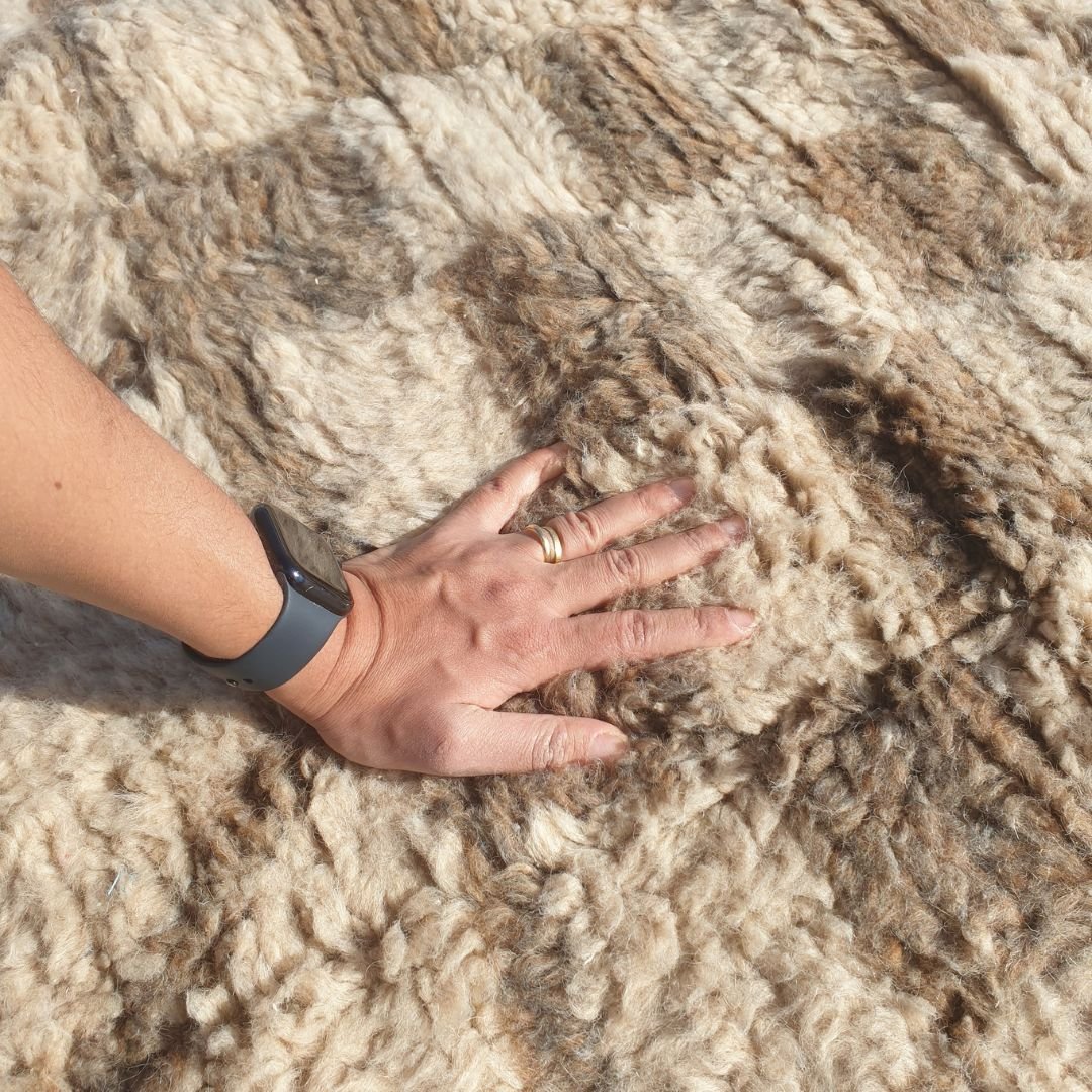 Ultra soft fluffy high-pile wool texture detail of ivory Beni Ourain plush shag rug